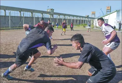  ?? EITAN ABRAMOVICH / AGENCE FRANCE-PRESSE ?? Inmates of the Unidad Penitencia­ria No 48 of San Martin, a prison outside Buenos Aires, Argentina, take part in the Espartanos rugby team’s weekly training session. Espartanos was formed in 2009 and has reduced recidivism from 65 percent to less than 5...