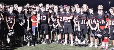  ?? ANNETTE BEARD PEA RIDGE TIMES ?? Blackhawk football team members joined fellow teammate Justin Blount, No. 83, Friday, Sept. 24, after the home football game as Blount surprised Danielle Martinez with a proposal. Martinez thought she was just joining the group for a photograph with their son, Austin Blake Blount, born Dec. 7, 2020.