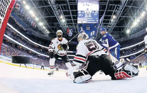  ?? AP ?? Blackhawks goalie Corey Crawford watches as the Lightning defenceman Jason Garrison’s goal flies by.