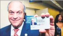  ?? Hearst Connecticu­t Media photos ?? Then-New Haven Mayor John DeStefano Jr. holds an Elm City Resident Card in 2007.