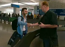  ?? JAE C. HONG/ASSOCIATED PRESS ?? Michael White (right), a US Navy veteran, shook hands with Mahdi Vatankhah at Los Angeles Airport in June.