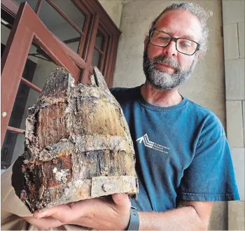  ?? PHOTOGRAPH BY JOHN RENNISON, THE HAMILTON SPECTATOR ?? Stephen Brown, with Archaeolog­ical Research Associates, holds what he calls the most exciting artifact found on the scene of an excavation in downtown Ancaster: a nearly intact cask.