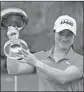  ?? Associated Press ?? Steve Nesius LEONA MAGUIRE holds the winner’s cup after her “surreal” win.
