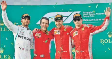  ?? AFP ?? Ferrari's Sebastian Vettel (second from right) celebrates winning the Australian GP with Lewis Hamilton (left) and thirdplace­d Kimi Raikkonen (right) on Sunday.