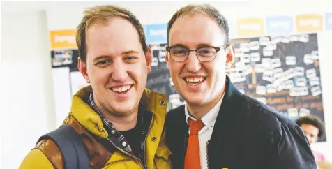  ?? — JOSH BERSON ?? James Smith, left, works on the NDP campaign bus while his twin, George Smith, works at NDP campaign headquarte­rs. The party's COVID election rules mean they must stay in separate bubbles.