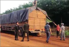  ?? SUPPLIED ?? Authoritie­s seize one of two timber trucks suspected of transporti­ng 35 cubic metres of first-grade timber to Vietnam on Friday in Tbong Khmum province.