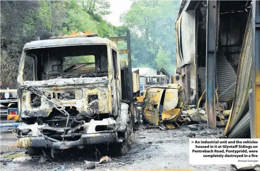  ?? Richard Swingler ?? > An industrial unit and the vehicles housed in it at Glyntaff Sidings on Pentrebach Road, Pontypridd, were completely destroyed in a fire