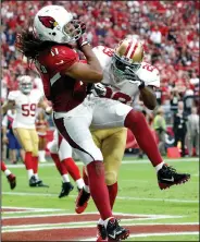  ?? AP PHOTO ?? Arizona Cardinals wide receiver Larry Fitzgerald scores as San Francisco 49ers strong safety Jaquiski Tartt defends.