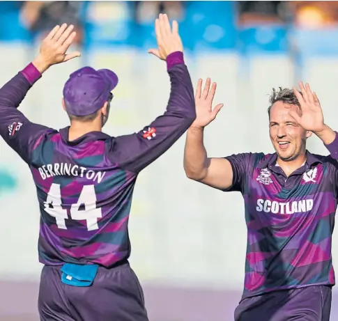  ?? ?? BOWLED OVER: Scotland’s Richie Berrington and Josh Davey celebrate at the World Cup last month.