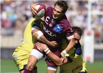  ??  ?? Bordeaux-Begles’ French scrumhalf Baptiste Serin is tackled during the French Top 14 rugby union match between Bordeaux-Begles and Clermont at the Chaban-Delmas stadium in Bordeaux, southweste­rn France. — AFP photo