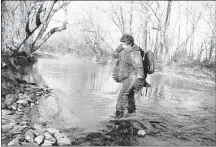  ?? PHOTO PROVIDED ?? Bill Cooksey, 14, of Bartlett, wades across a Perry County stream with the turkey he killed during Tennessee’s Young Sportsman’s Weekend on March 28-29. Statewide, 1,071 turkeys were taken over the weekend.