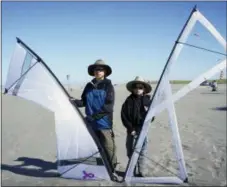  ?? P.V. NGUYEN VIA AP ?? Left, and Cardin Nguyen are shown holding their kites and enjoy flying and competing at the Washington State Internatio­nal Kite Festival in Long Beach, Wash.