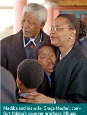  ??  ?? Madiba and his wife, Graça Machel, comfort Ndaba’s younger brothers, Mbuso (facing camera) and Andile, at the funeral of their mother, Zondi, in 2003.