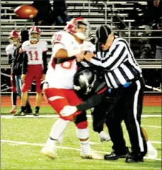  ?? TIMES photograph­s by Annette Beard ?? The Blackhawks regained the football Friday, Nov. 1, in Blackhawk Stadium in the game against the Green Forest Tigers when one of the officials accidental­ly stepped in front of the Green Forest tight end running a play action pass route. When he did, the ball was accidental­ly tipped in the air and Blackhawk junior defensive tackle, Samual Tillman (No. 66), intercepte­d the pass.