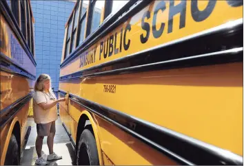  ?? Hearst Connecticu­t Media file photo ?? Roxanne Pagniello, of Danbury, goes through a pre-trip checklist before making a practice run of her bus route on Aug. 24, 2012. Pagniello was starting her second year as a school bus driver for Student Transporta­tion of America in Danbury, driving students from Danbury High and two elementary schools.