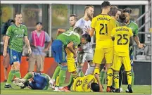  ??  ?? Players from the Crew and Sounders argue during the second half after a physical play.