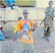  ?? Picture: LIESL LOUW ?? STOLEN INNOCENCE: A child soldier in Bunia. DRC law criminalis­es all forms of sex traffickin­g, but not all types of labour traffickin­g.