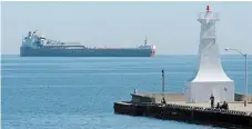  ?? BARRY GRAY THE HAMILTON SPECTATOR ?? A lake freighter waits near the Burlington canal piers in 2004. The federal government plans to ban public access to the historic piers.