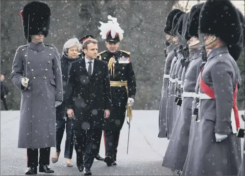  ?? PICTURE: STEFAN ROUSSEAU/PA WIRE. ?? BON ACCORD: Theresa May and Emmanuel Macron view a guard of honour at the Royal Military Academy Sandhurst ahead of talks yesterday.