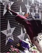  ?? TNS ?? Terrance May, a musician who goes by May Millions, visits a makeshift memorial for Prince in Minneapoli­s.