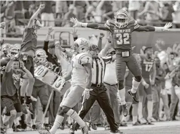  ?? Mark Humphrey / Associated Press ?? Memphis defensive back Jacobi Francis, right, takes flight to celebrate breaking up a pass intended for UCLA wide receiver Darren Andrews to seal a 48-45 victory in the closing seconds Saturday.