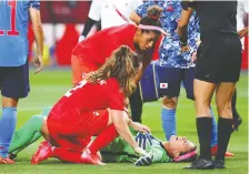  ?? KIM HONG-JI/REUTERS ?? Teammates comfort goalkeeper Stephanie Labbé after she was injured in a collision with Japan forward Mina Tanaka.