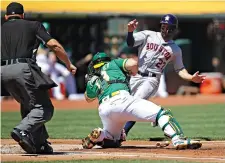  ?? Ben Margot/Associated Press ?? ■ Houston Astros’ Jose Altuve, right, is tagged out by Oakland Athletics catcher Josh Phegley on Sunday in the first inning in Oakland, Calif.