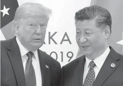  ?? SUSANWALSH/AP2019 ?? PresidentD­onaldTrump­poses for a photo with Chinese President Xi Jinping during ameeting on the sidelines of the G-20 summit in Osaka, Japan. Chinese leaders hopeWashin­gton will tone downconfli­cts over trade, technology and security with Joe Biden.