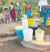  ??  ?? At a borehole opening where water is found in the community for the very first time.