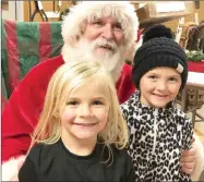  ?? TIMES file photograph ?? In 2018, sisters Kenzie, 4, and Kelia Brantley, 6, daughters of Travis and Melanie Brantley, visited Santa Saturday night after the annual Christmas parade.