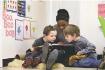  ?? ELAINE THOMPSON/ASSOCIATED PRESS FILE PHOTO ?? Assistant teacher D’onna Hartman reads to students in 2016 in Seattle. In perhaps an unexpected twist, historical­ly conservati­ve stronghold­s like Oklahoma and West Virginia are leading efforts to bring preschool to all and Alabama and Georgia are also...