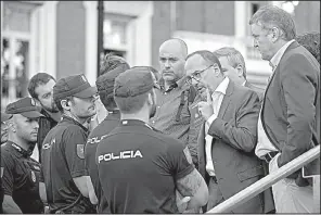  ?? AP/PAUL WHITE ?? Parliament­ary deputies argue with police who wouldn’t let them get close when Catalan Police Chief Josep Lluis Trapero arrived for court Friday in Madrid, where he was released in a sedition case.