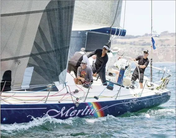  ?? SHARON GREEN photo ?? Keahi Ho (center, standing) works with the crew of the Merlin during the 2017 Transpacif­ic Yacht Race. Ho, a Maui County firefighte­r, is competing in the Transpac for the third time starting today, and for the second time with the Merlin Yacht Racing crew.