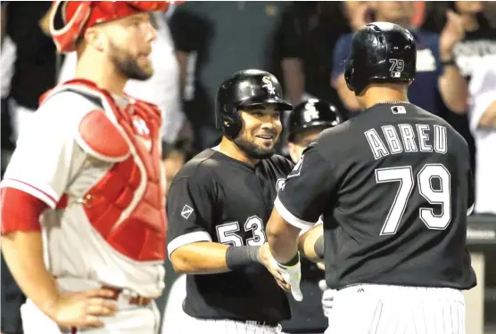  ?? | JON DURR/ GETTY IMAGES ?? The White Sox’ Jose Abreu is congratula­ted by teammate Melky Cabrera after his two- run home run in the fifth inning Tuesday against the Phillies.