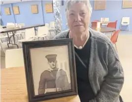  ?? DARRELL COLE ■ SALTWIRE NETWORK ?? Susan Boudreau sits with a photograph of her brother, Roderick Reade, who was killed in a fire on the HMCS Nipigon in October 1965. Reade’s memory is recognized in the renaming of a brook in Brookdale near Amherst in his honour.