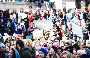  ?? —AFP photo ?? Protesters hold up placards during the Women’s March in London.