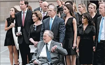  ?? SCOTT OLSON/GETTY ?? Former Presidents George H.W. Bush and son George W. Bush and family pay respects as the coffin of former first lady Barbara Bush is placed in a hearse Saturday in Houston.