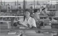  ?? XINHUA ?? A local employee works on a ceramic tile production line at an industrial park, the first China-invested joint venture industrial park, in Uzbekistan.