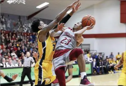  ?? JOHN BLAINE — FOR THE TRENTONIAN ?? Rider’s Stevie Jordan (23) attempts a shot over the defense of Canisius’ Jonathan Banks (3) during a MAAC game last season. The Broncs open league play on Jan. 3 at Fairfield.