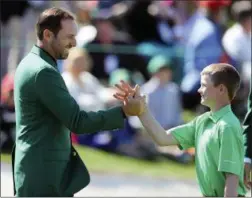  ?? CURTIS COMPTON — ATLANTA JOURNAL-CONSTITUTI­ON VIA AP ?? Defending Masters champion Sergio Garcia, left, greets Nicholas Gross, of Downingtow­n, after Gross’ putt on the 18th green to win the putting championsh­ip for his age group during the Drive Chip Putt National Finals at Augusta National Golf Club on...