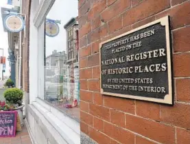  ?? KIM HAIRSTON/BALTIMORE SUN ?? A National Register of Historic Places marker is affixed to the front wall of the Women’s Industrial Exchange at 333 N. Charles St.