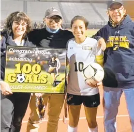 ?? BYTHE GSCHREYFAM­ILY CONTRIBUTE­D ?? Freedom senior soccer player Haley Gschrey celebrates scoring her 100th career goal with, from left, mother, Deborah, brother, Michael and father, Stephen.