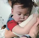  ?? ALFIES ARMY OFFICIAL THE ASSOCIATED PRESS ?? Alfie Evans is held by his mother Kate James at Alder Hey Hospital, Liverpool, England.