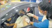  ?? PARVEEN KUMAR/HT ?? A health worker administer­s Covid vaccine to a woman at a drive-in facility in Gurugram on Saturday.