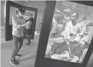  ?? JOHN WALKER /THE FRESNO BEE VIA AP ?? Ed Hung, of San Francisco, takes a photo of a Chinese laborer in an exhibit in the restored 1917 Chinese laundry building after its Oct. 1 dedication in Yosemite National Park, Calif.