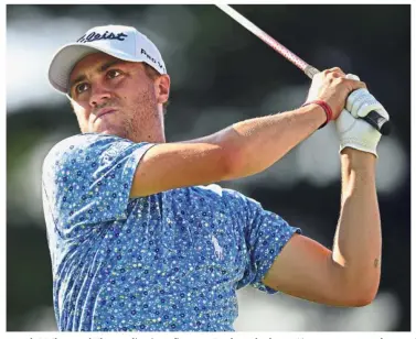  ?? — AP ?? All eyes: Justin Thomas watches his tee shot on the 17th hole during the third round of the Bridgeston­e Invitation­al golf tournament at the Firestone Country Club on Saturday.