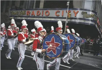  ?? EDUARDO MUNOZ ALVAREZ/AP ?? REVELERS MAKES THEIR WAY DOWN the Avenue of the Americas in front of Radio City Music Hall during the Macy’s Thanksgivi­ng Day Parade in New York on Nov. 28, 2019.