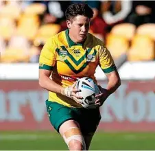  ?? Photo: DAVID ROWLAND ?? DEPARTING ON A HIGH: Heather Ballinger taking a hit up for Australia in her final game of rugby league.