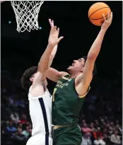  ?? DYLAN BUELL/GETTY IMAGES ?? Colorado State’s Joel Scott shoots over Virginia’s Blake Buchanan in Tuesday’s NCAA First Four play-in game.