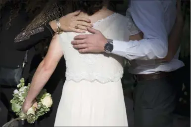  ?? ARIEL SCHALIT — THE ASSOCIATED PRESS ?? In this Thursday photo, a bride hugs her friends during her wedding in Ein Hemed. A growing number of Israeli couples are defying the country’s Chief Rabbinate and marrying in unsanction­ed weddings. The couples include people who have difficulty...